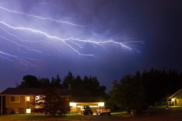 lightning above a home during a storm
